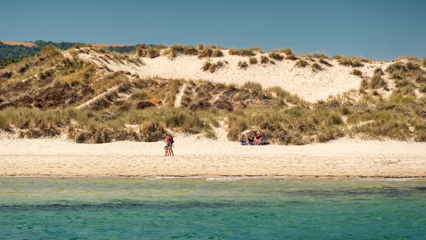 Knoll Beach at Studland, with the sand dunes behind it, seen from the water
